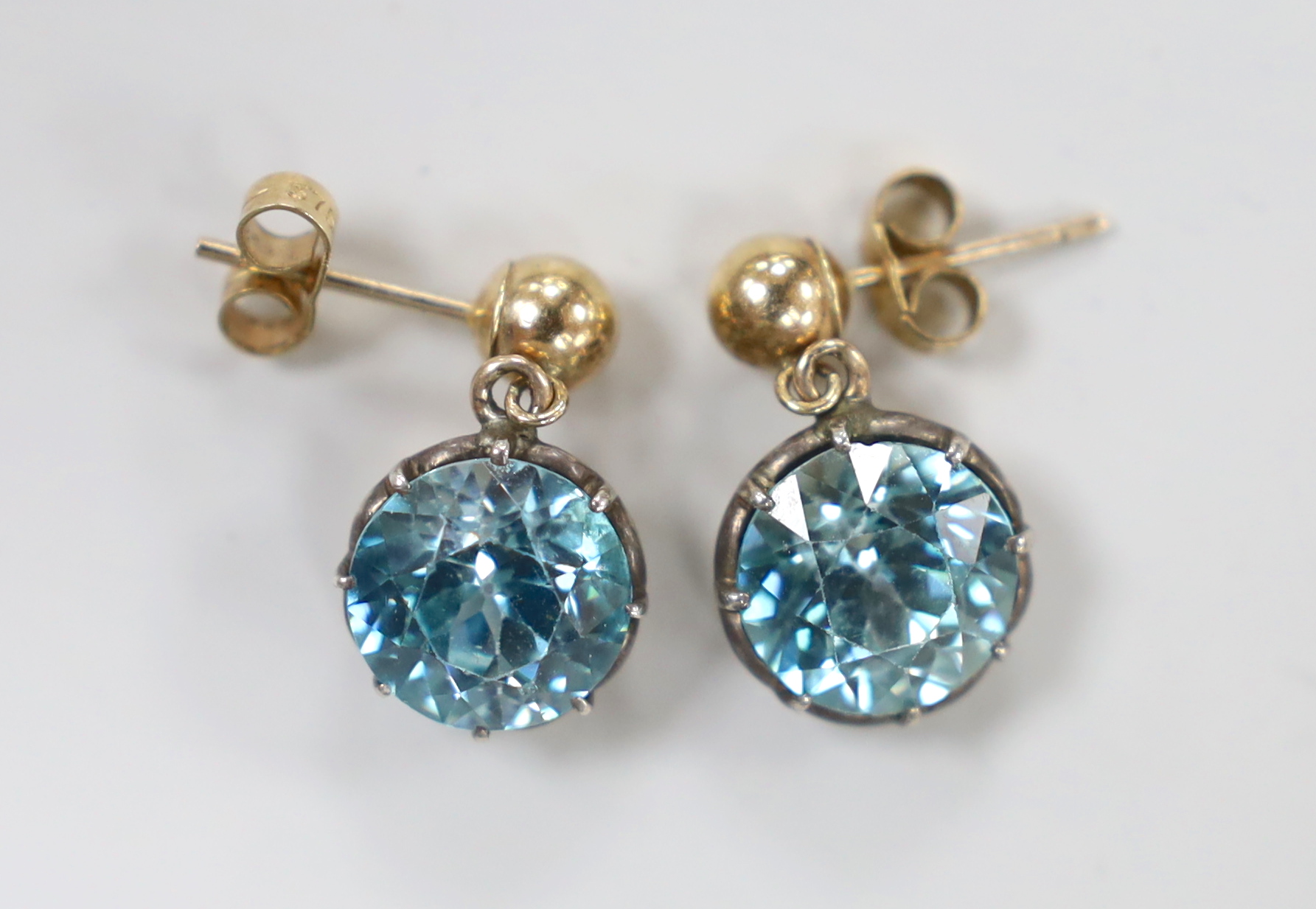 A pair of 375 yellow metal and blue zircon set earrings, 9mm, gross weight 4.4 grams.